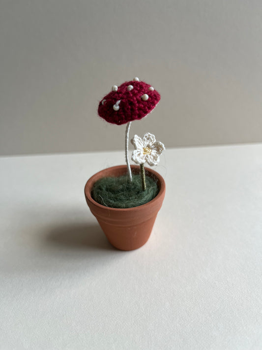 Tiny potted mushroom and flower